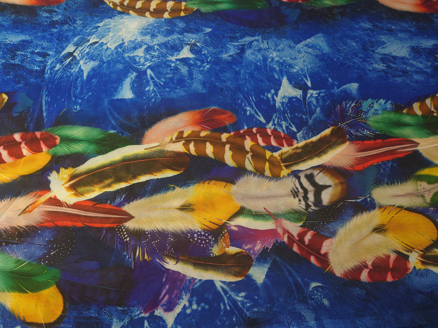 Multicoloured feathers on a blue background
Crepe de chine