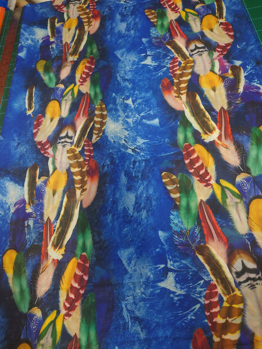Multicoloured feathers on a blue background
Crepe de chine